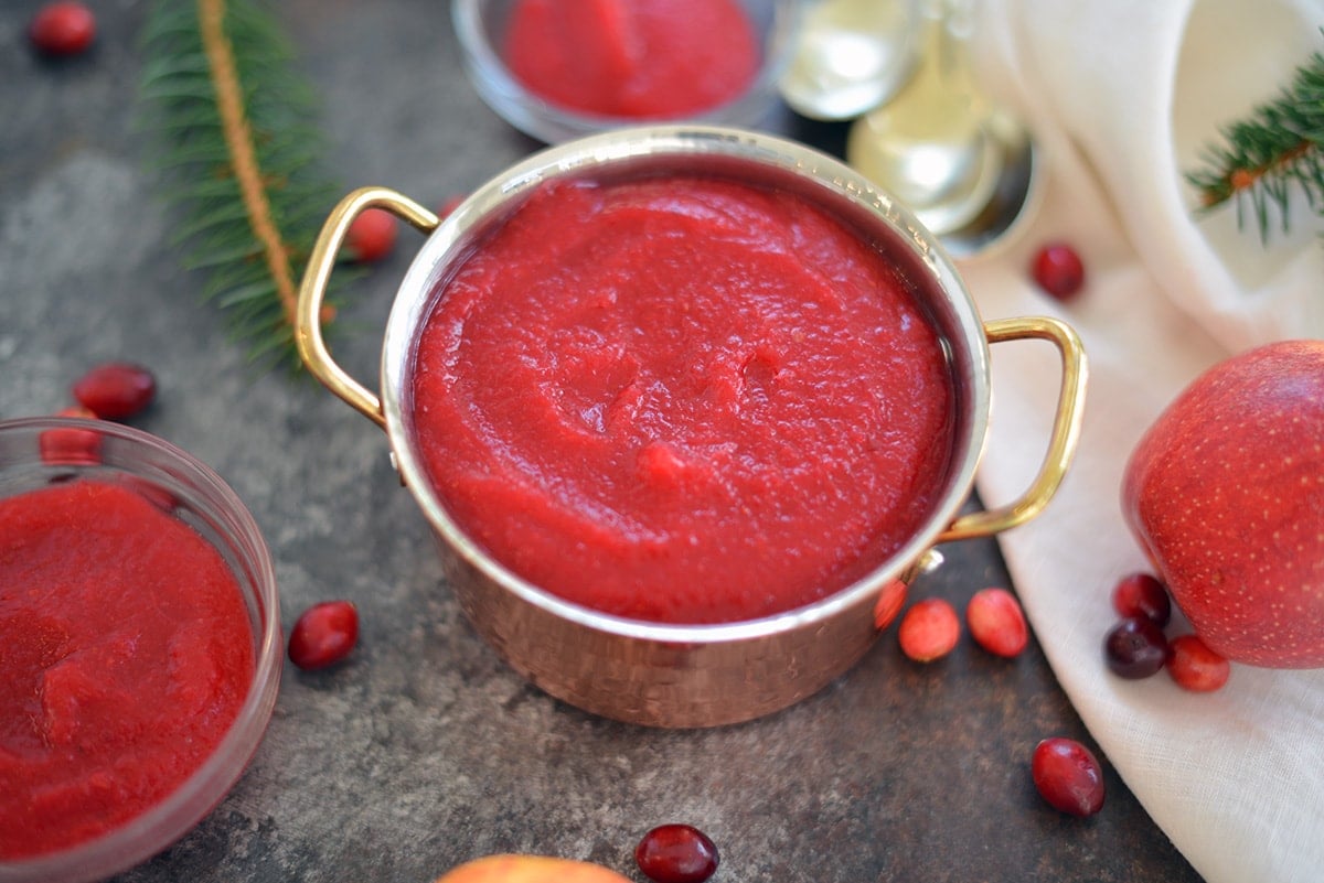 close up angle of apple cranberry sauce in a copper pot