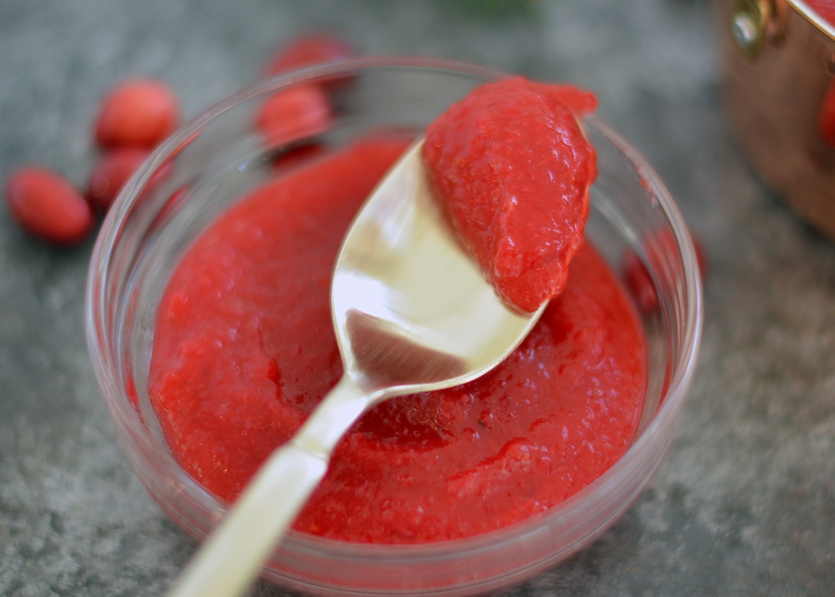 cran applesauce on a gold spoon