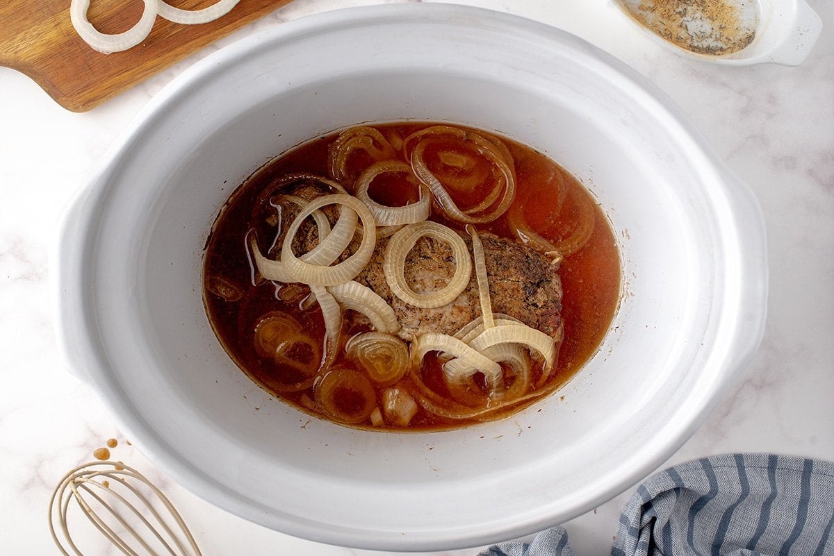 cooked onion and broth in a crock pot