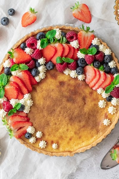 overhead of classic custard pie with berries