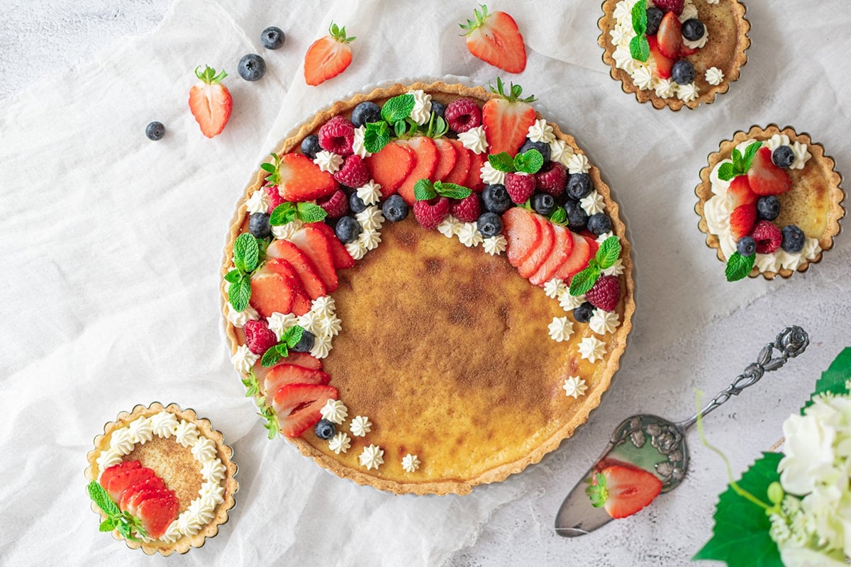 overhead of classic custard pie with berries