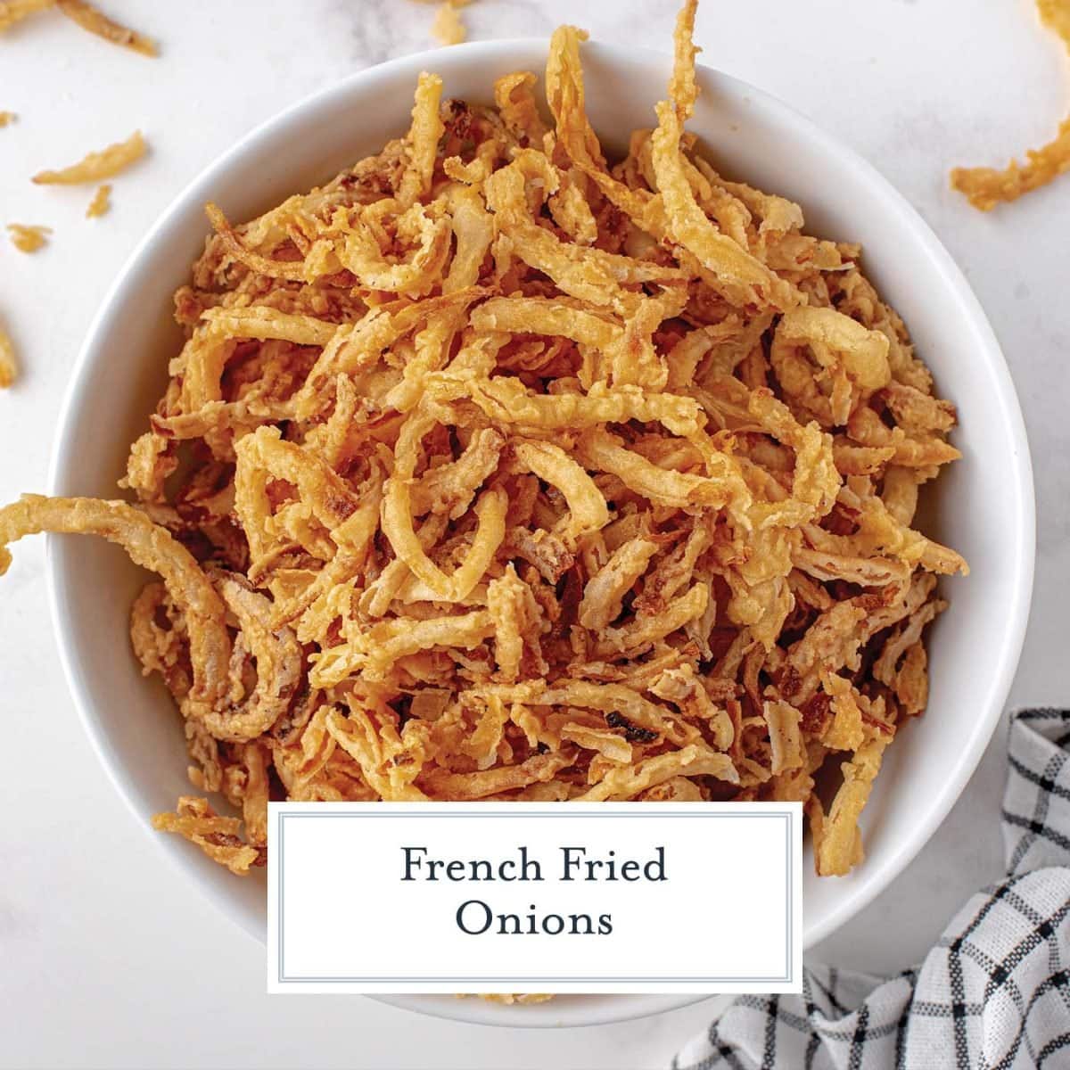 overhead close up of french fried onions in a white bowl 