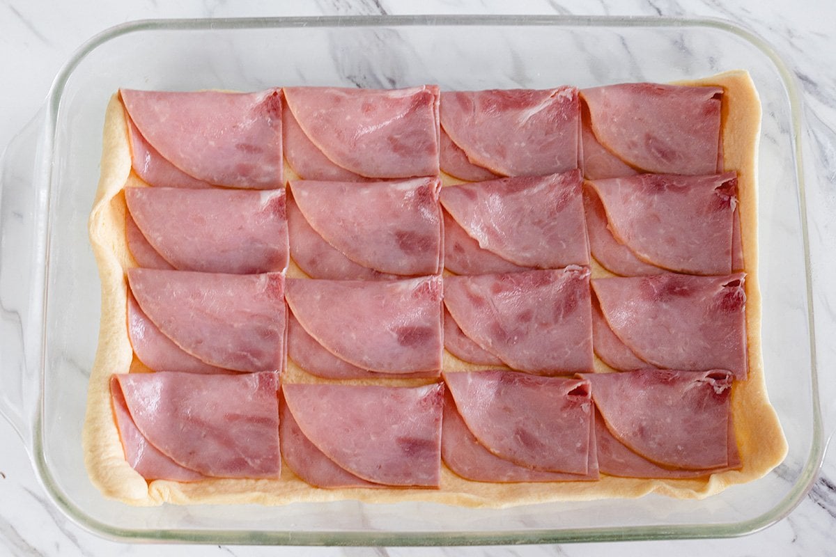 ham and cheese layered on crescent dough 
