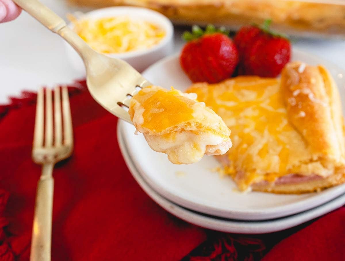 fork holding a cheesy piece of breakfast casserole 