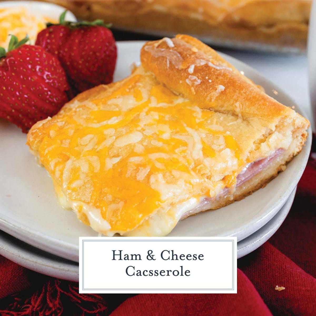 close up slice of ham and cheese casserole with strawberries