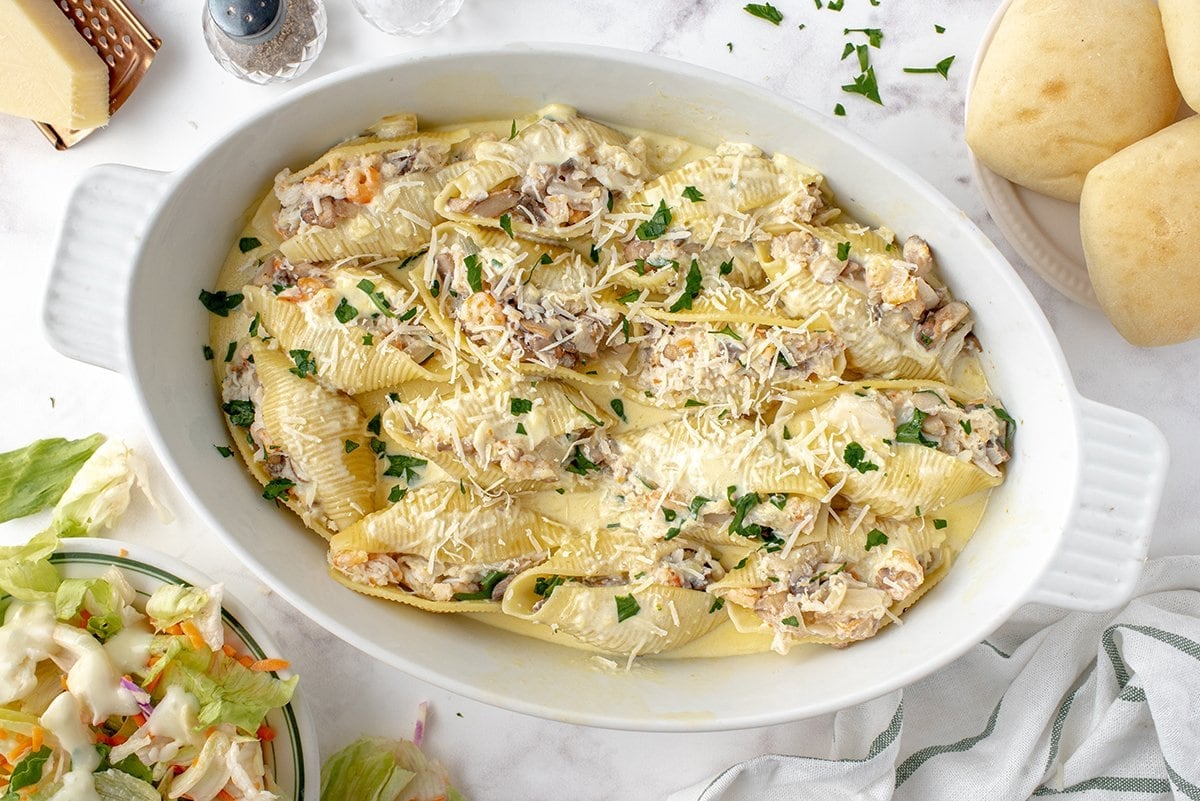 overhead of seafood stuffed shells in a creamy sauce 