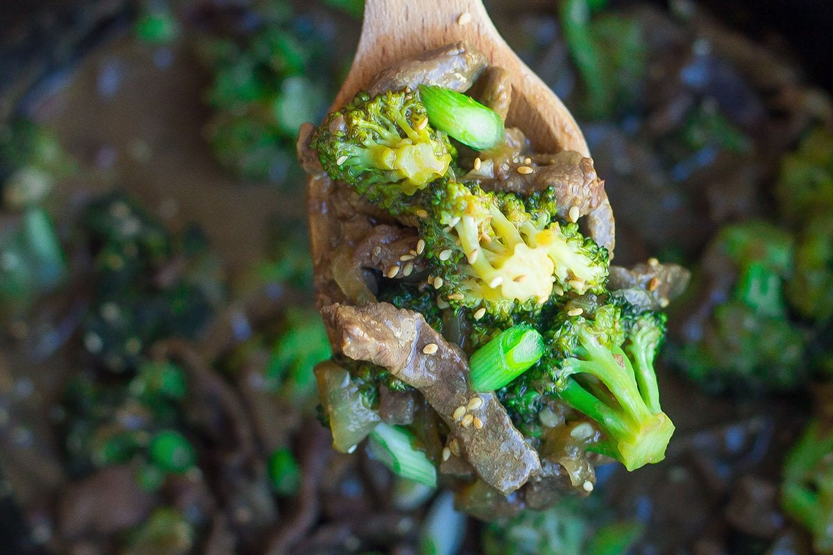 wooden spoon holding beef and broccoli 