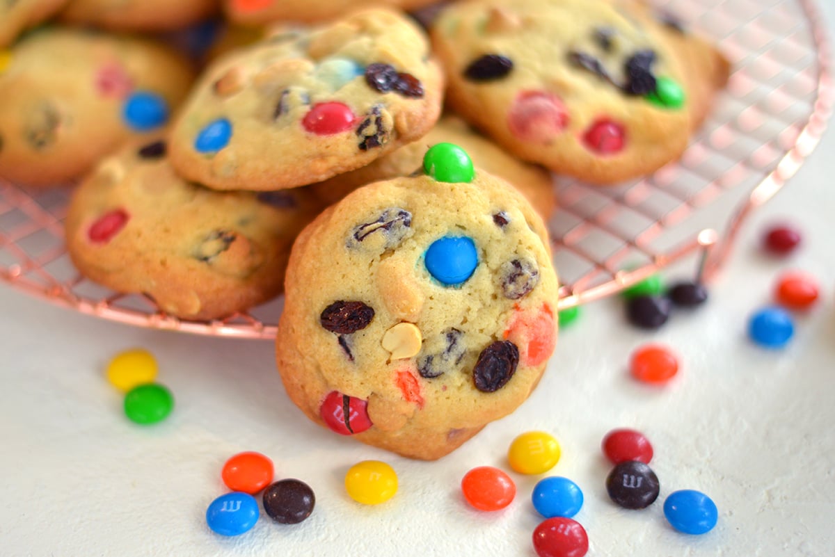 close up of a cookie dotted with peanuts, raisins and candy 