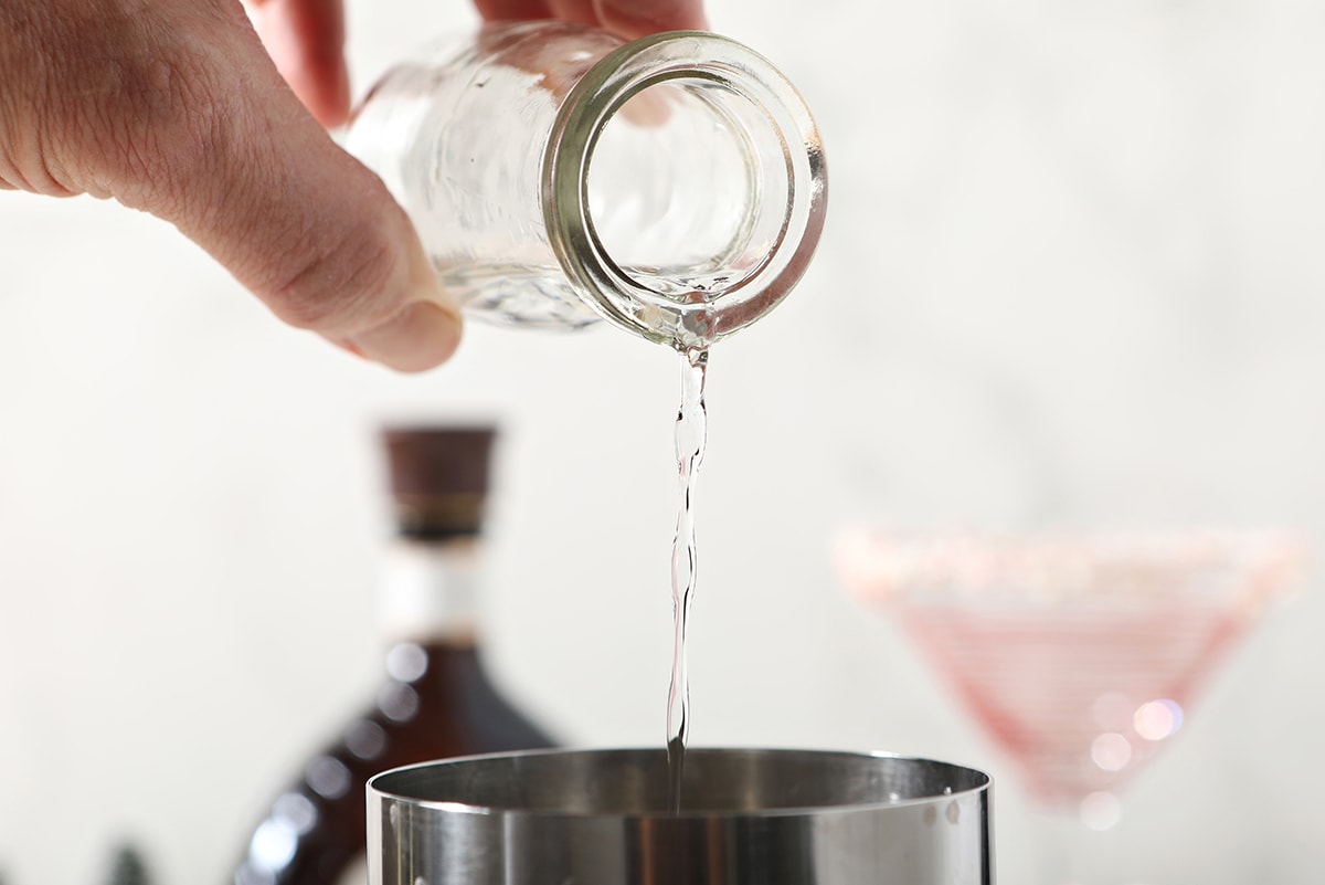 vodka pouring into a shaker 