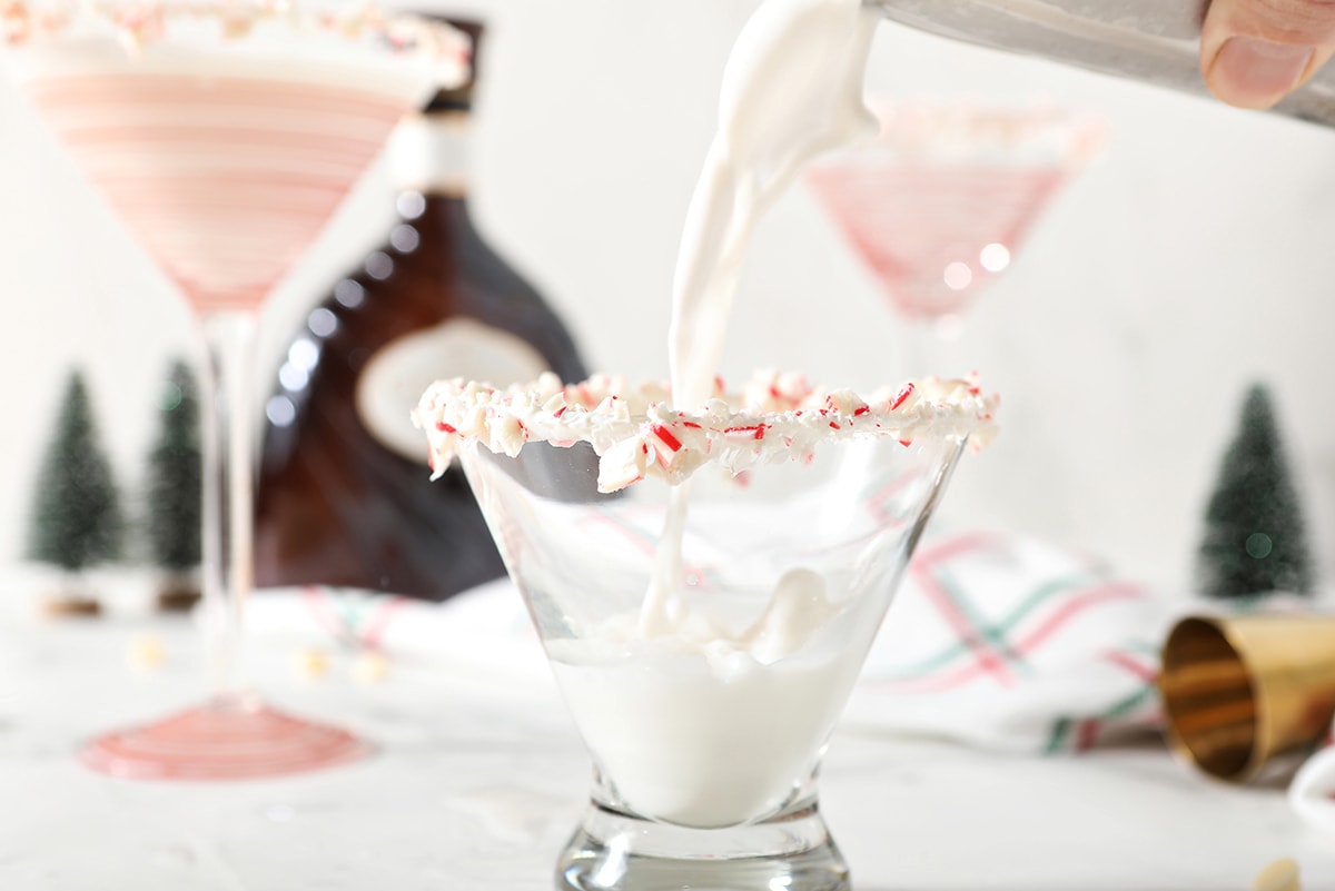 pouring white chocolate martini into a glass 