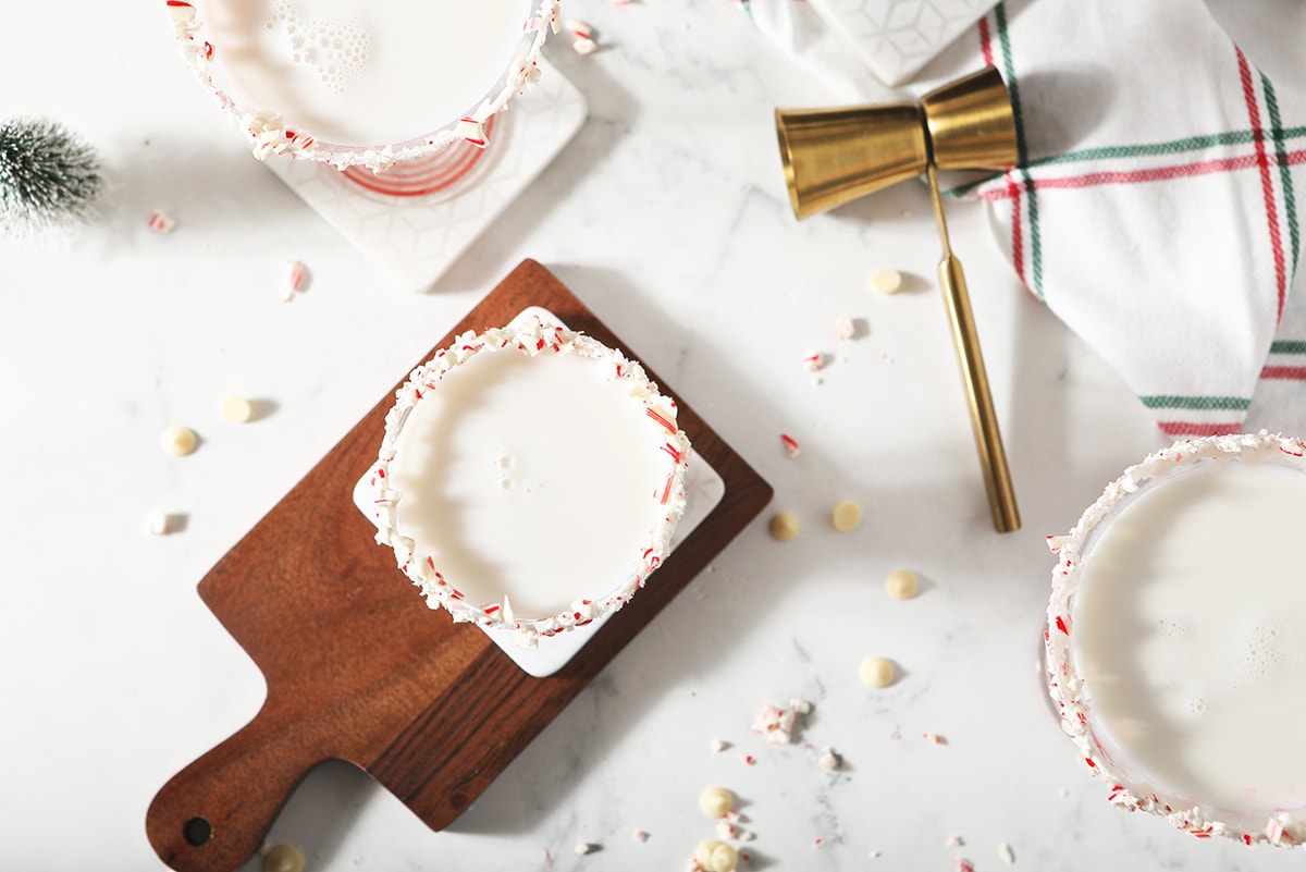 overhead of white chocolate martinis with holiday garb 