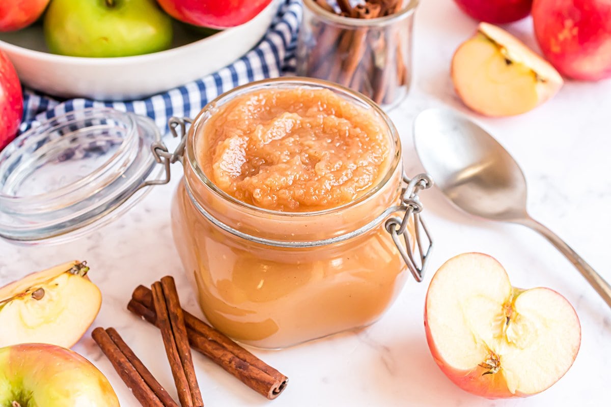 applesauce in a mason jar surrounded by ingredients 