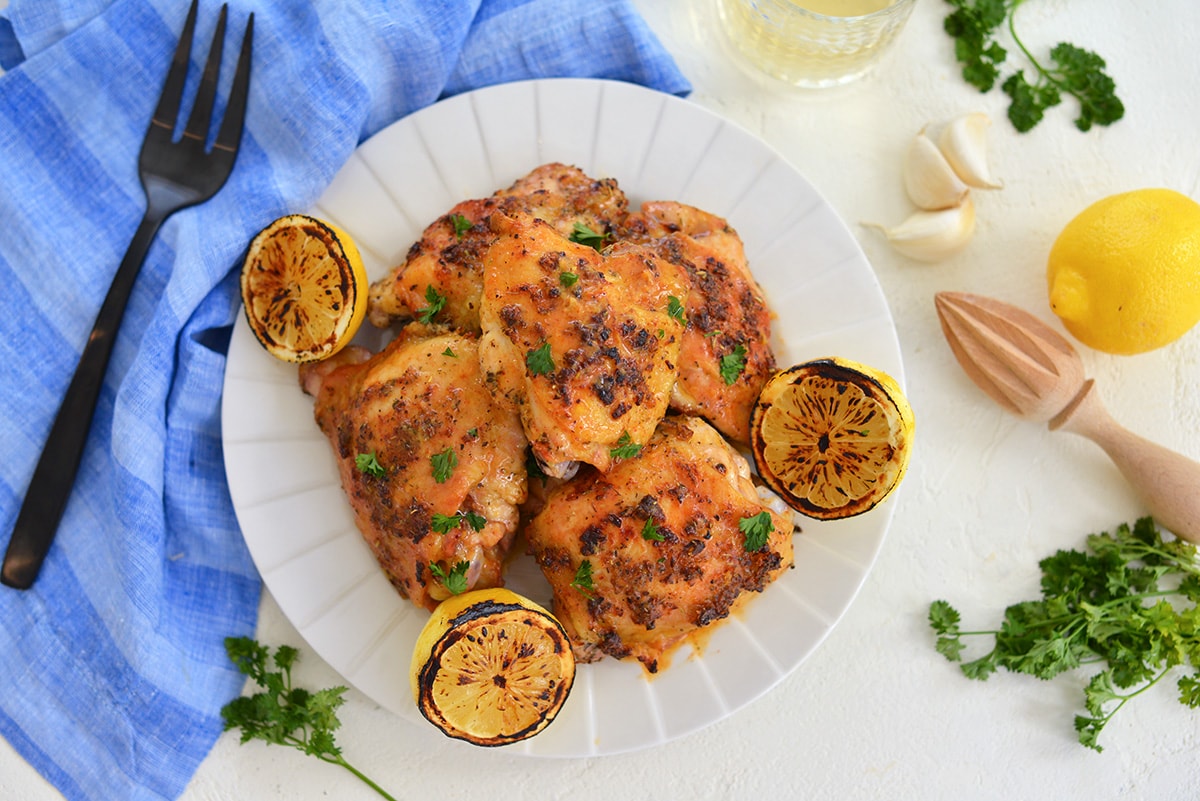 serving platter of baked chicken with butter sauce 