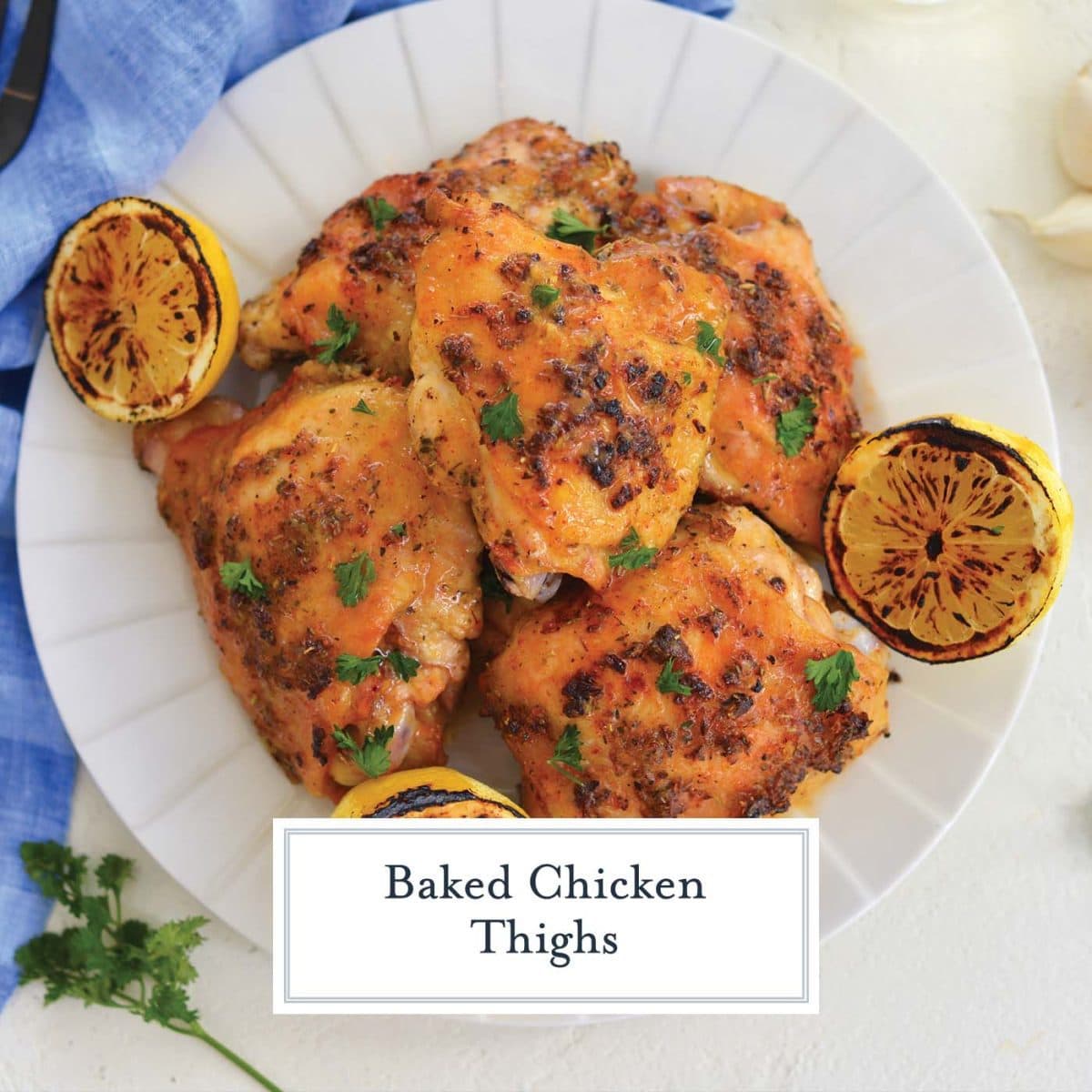 overhead plate of crispy chicken thighs with charred lemons