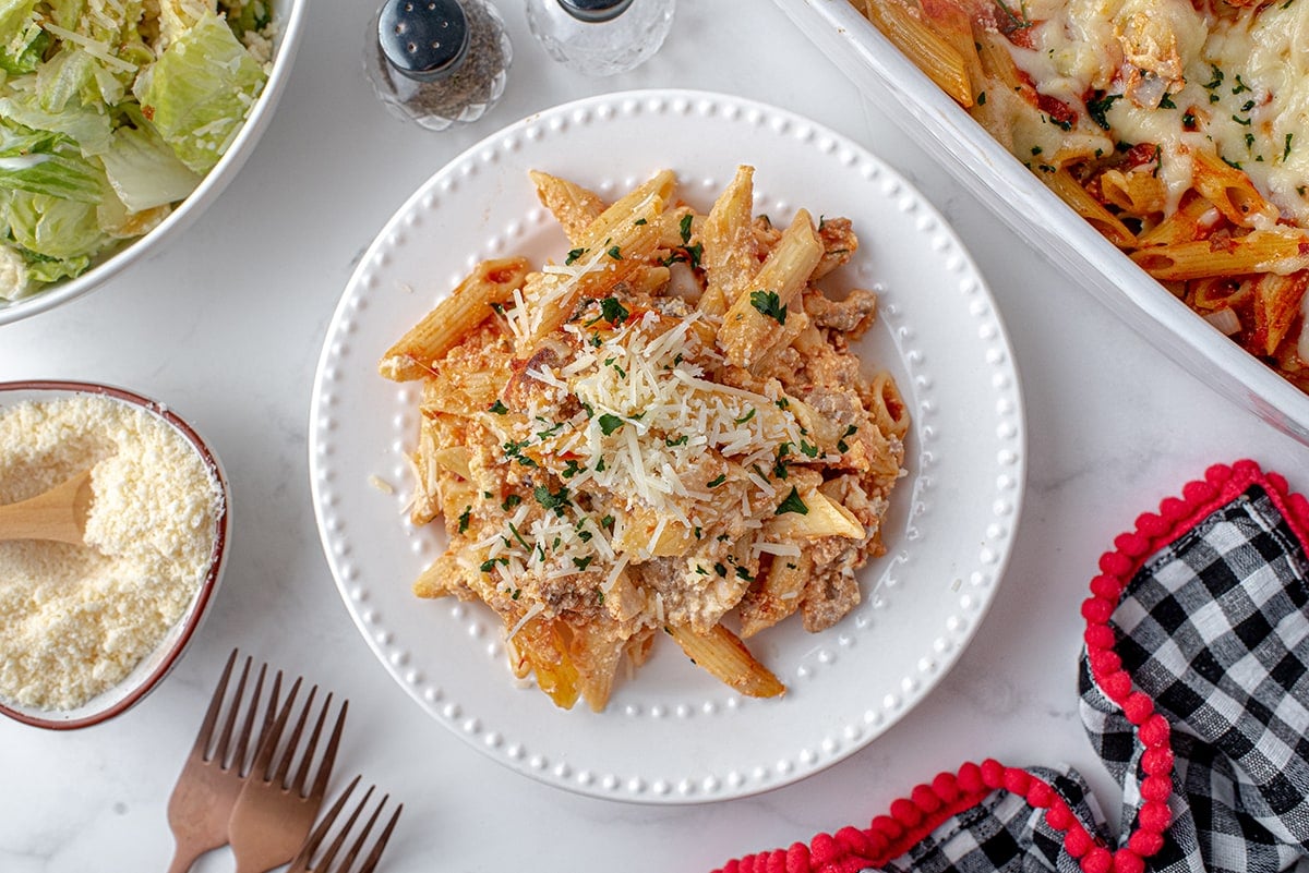 white plate of baked pasta with extra cheese 