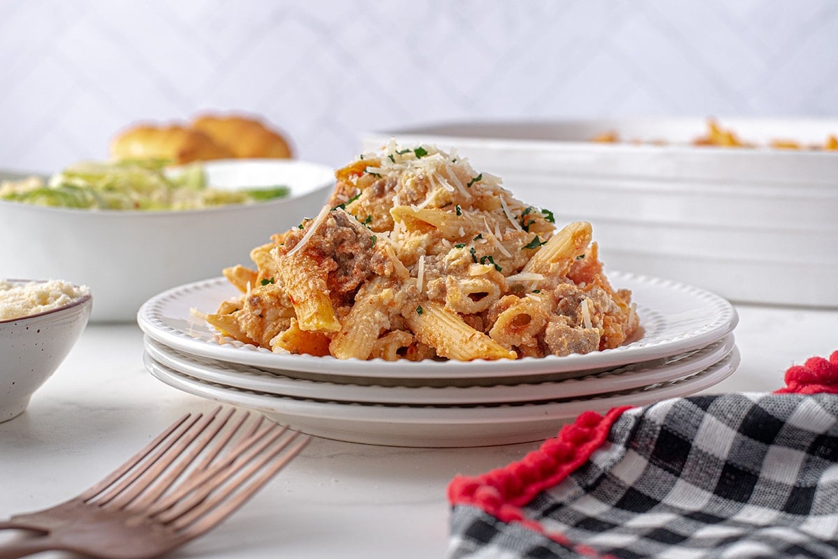 side angle view of pile of baked pasta on plates 