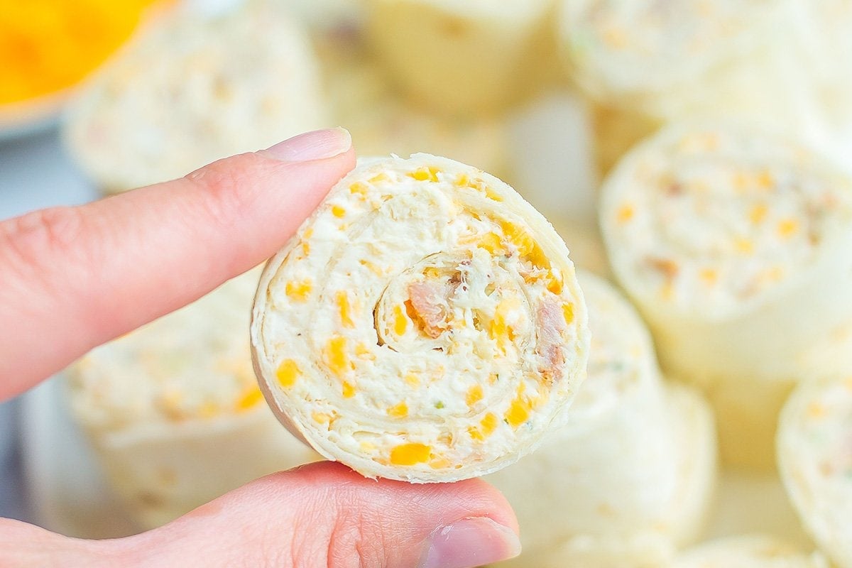 hand holding up a tortilla pinwheel 