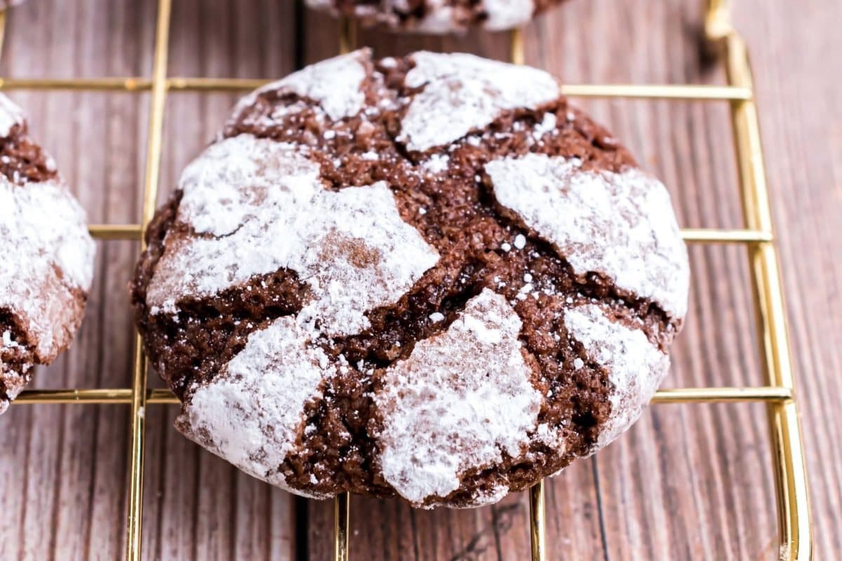close up of chocolate crinkle cookie with powdered sugar 