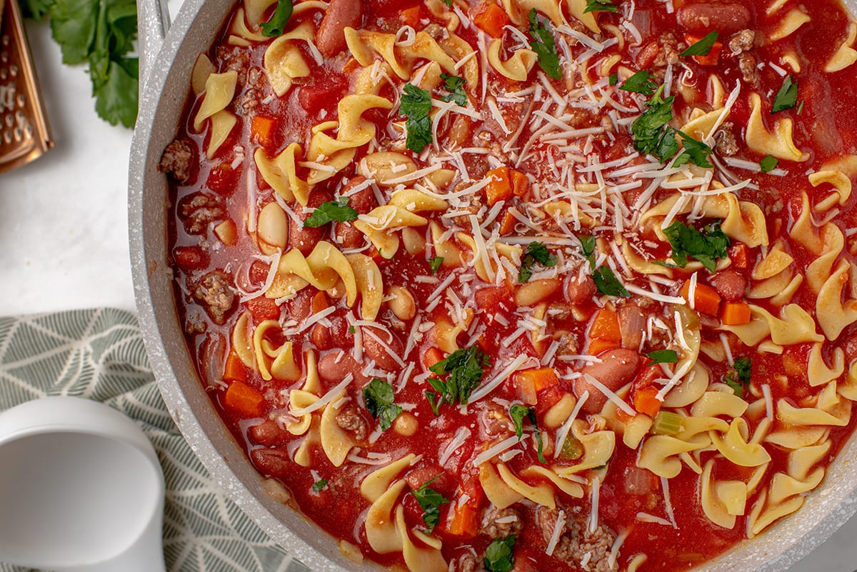 close up of tomato based soup with parmesan topping 