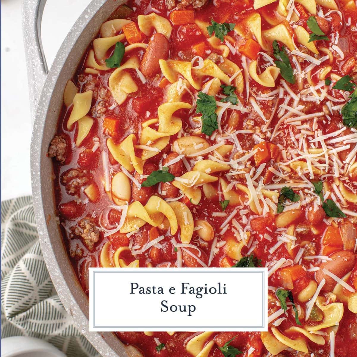 extreme close up of pasta and bean soup with tomato base