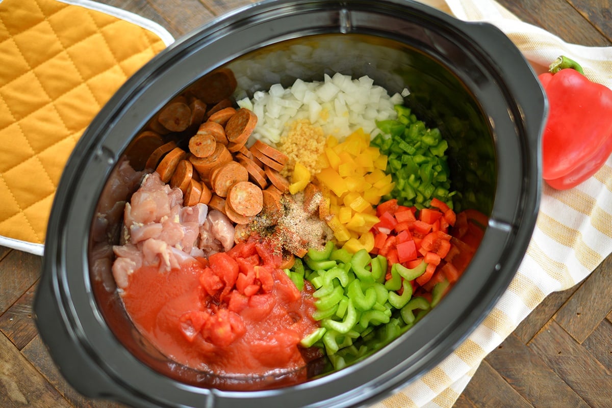 ingredients for crockpot jambalaya in a slow cooker bowl 