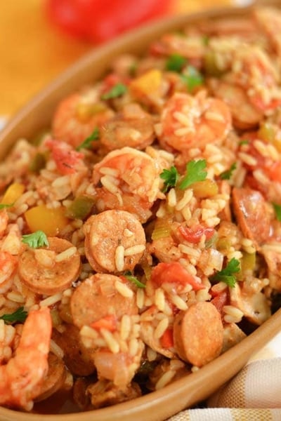 crockpot chicken jambalaya served in brown bowl with shrimp sausage and rice