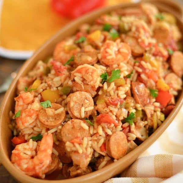 crockpot chicken jambalaya served in brown bowl with shrimp sausage and rice