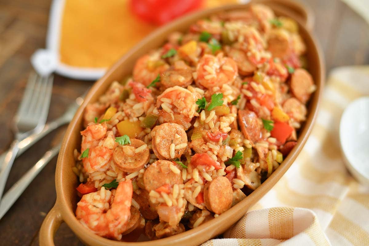 angle of chicken jambalaya in a brown serving dish 