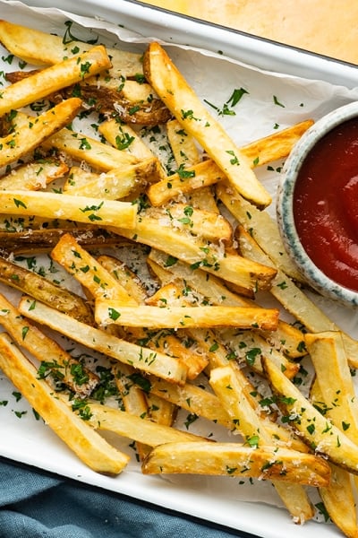 overhead of a tray of french fries with dipping sauces