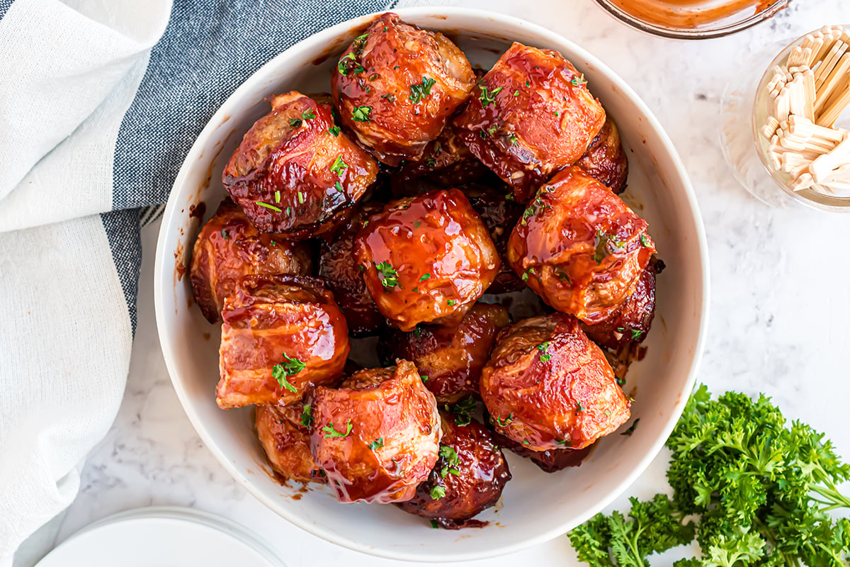 overhead bowl of bacon wrapped meatballs with parsley garnish 
