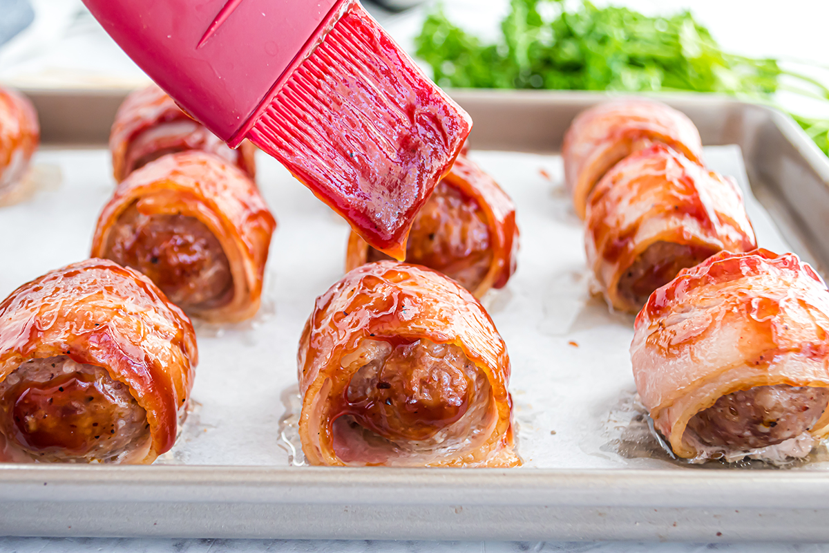 spatula basting meatballs with BBQ sauce 