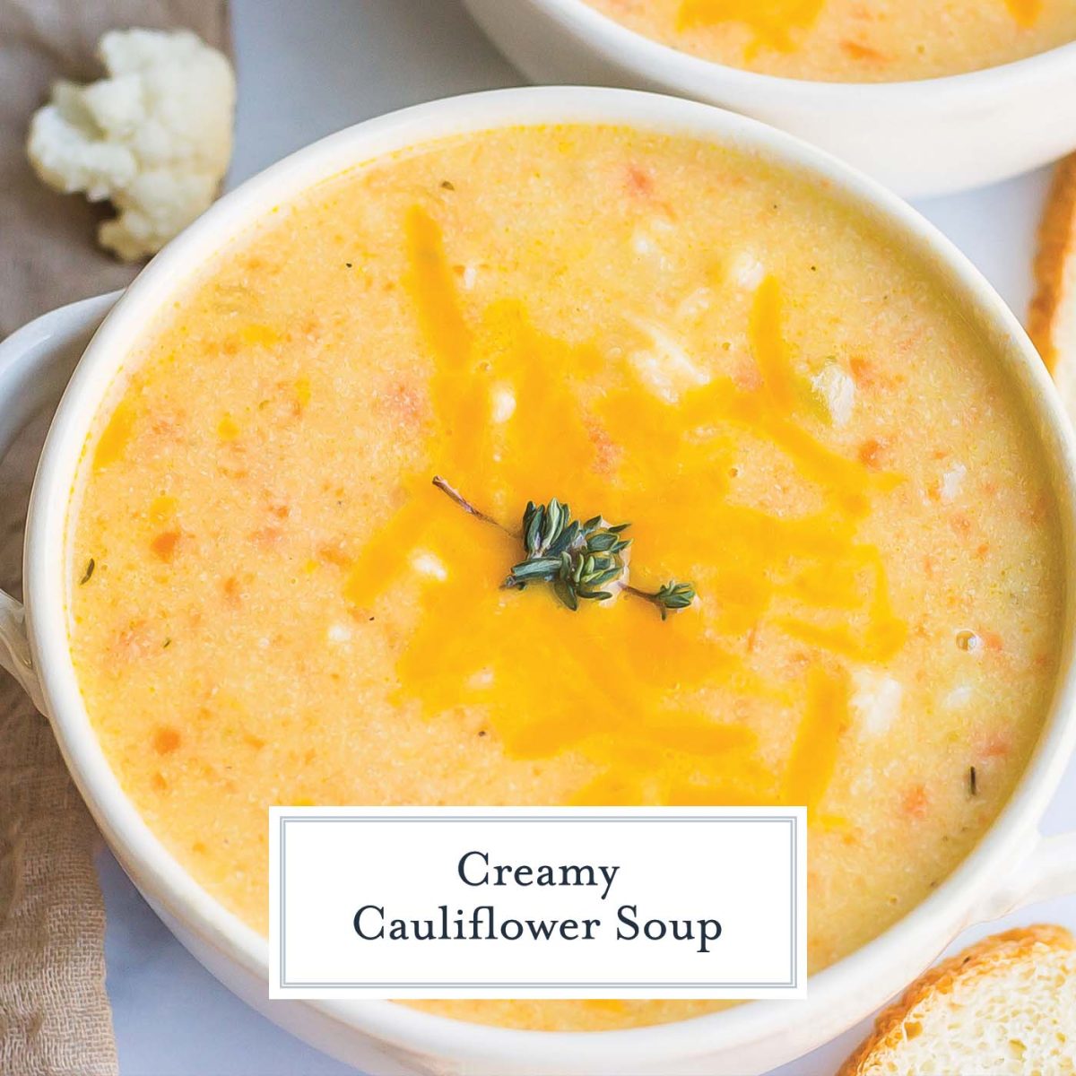 overhead close up of cheesy cauliflower soup with fresh thyme 