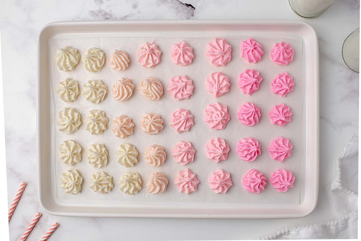 ombre colored cream cheese candies on a baking sheet 