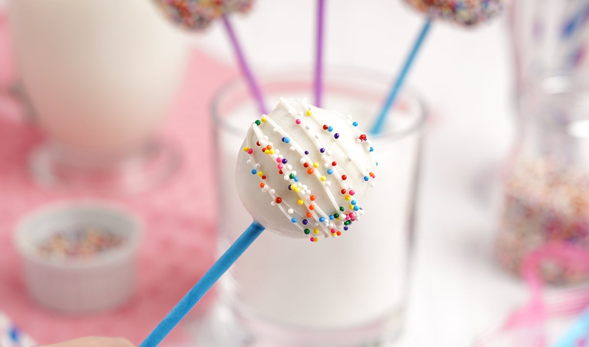 close up of white chocolate cake pops with sprinkles 