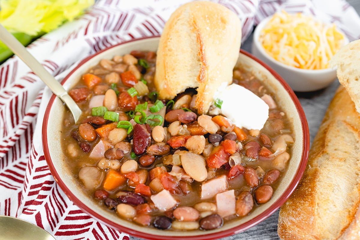 bread dipping into bowl of 15 bean soup