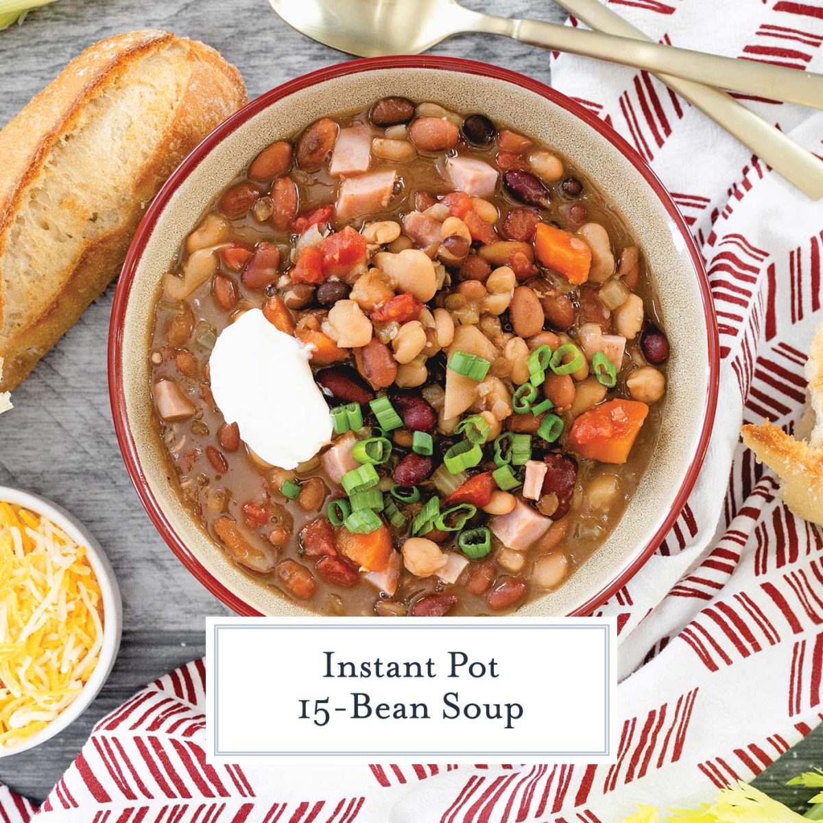 Overhead of bean soup recipe in a red bowl with bread and scallions