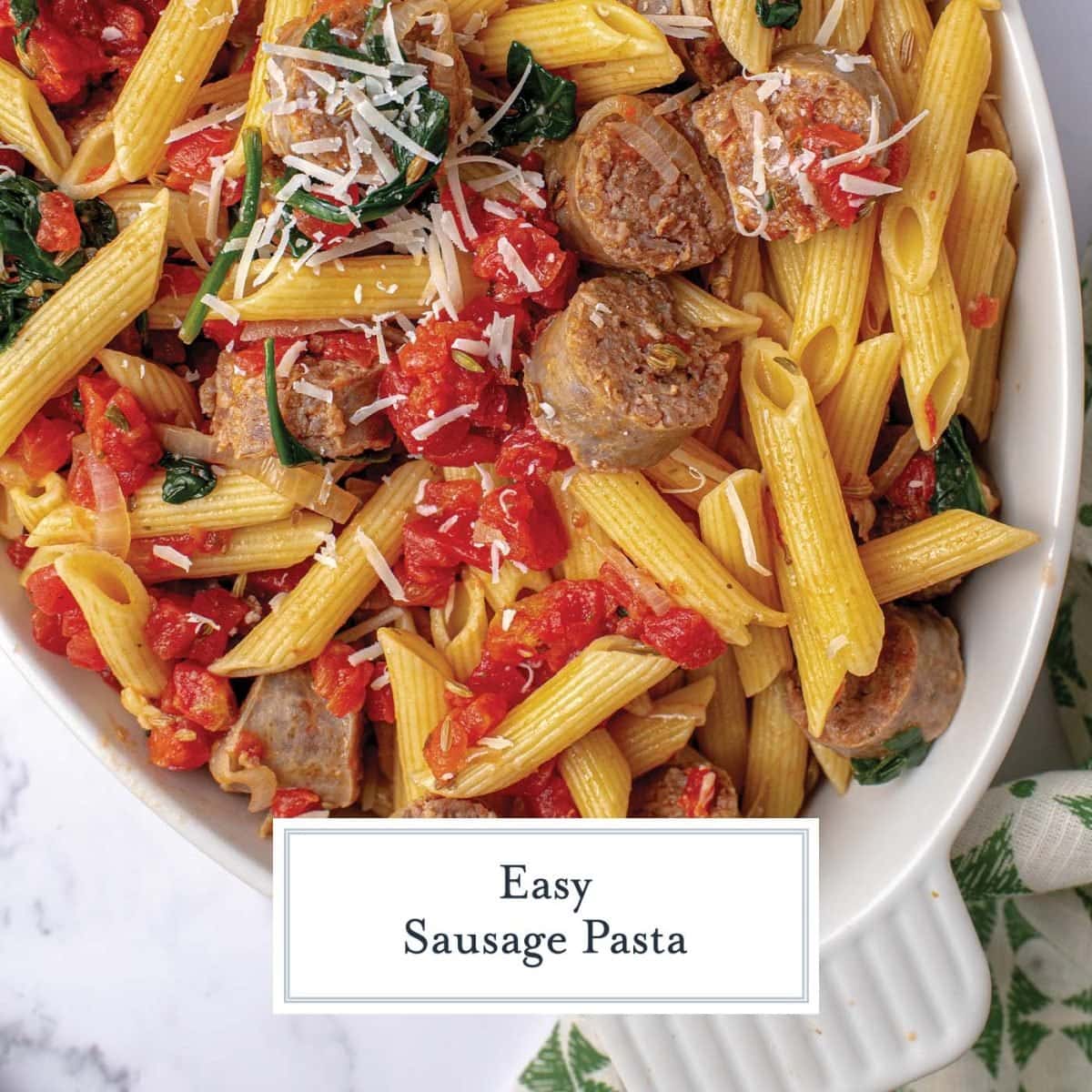 close up of sausage pasta with parmesan cheese and spinach 