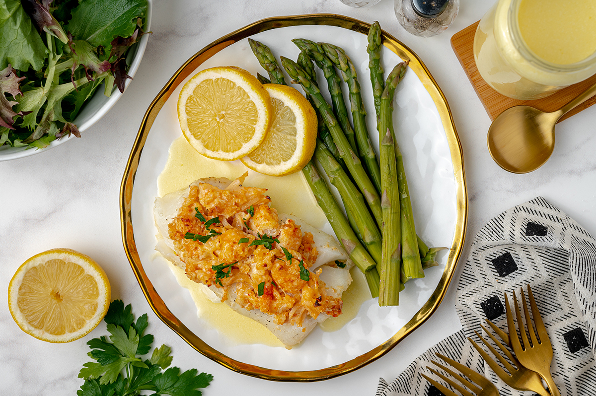 fish topped with lobster, asparagus, lemon and butter sauce