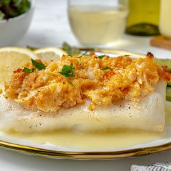 side angle of baked cod topped with lump lobster meat