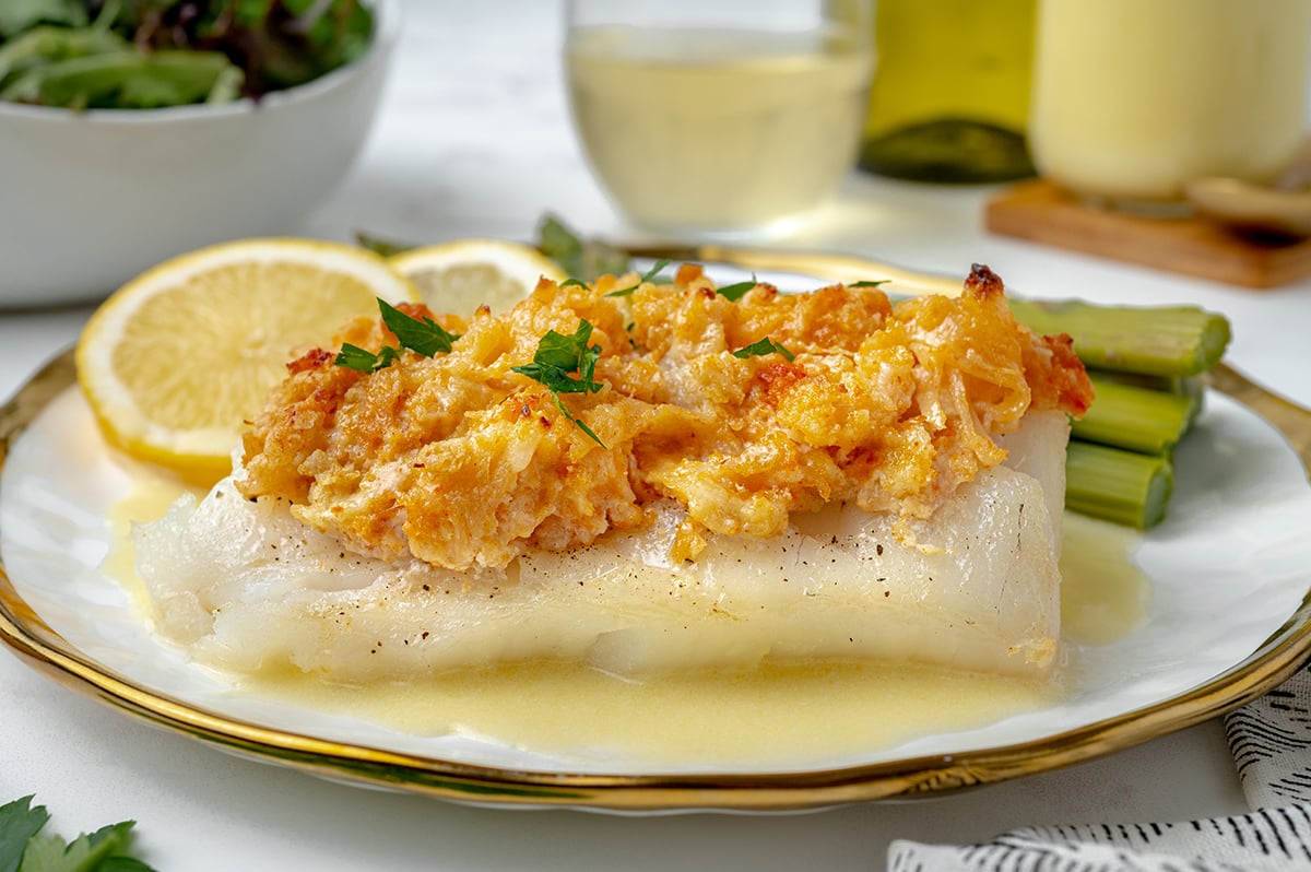 side angle of baked cod topped with lump lobster meat