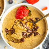 spoon digging into a bowl of creamy baked oats