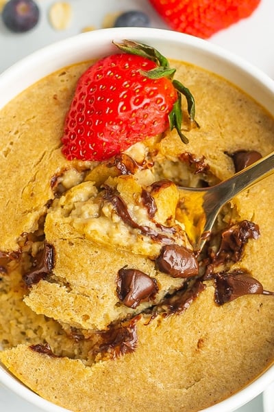 spoon digging into a bowl of creamy baked oats