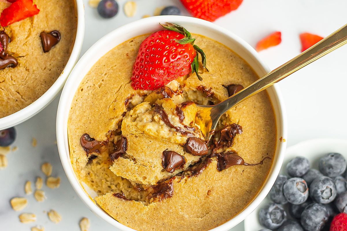 spoon digging into a bowl of creamy baked oats