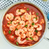 buttered shrimp in a tomato sauce in a cooking vessel