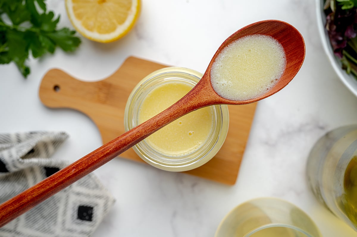 wooden spoon with lemon beurre blanc in the well 