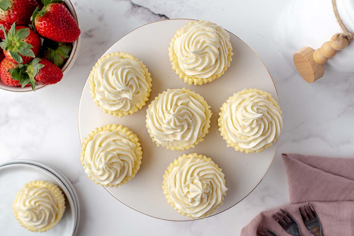 overhead of five mini cheesecakes on a serving platter 