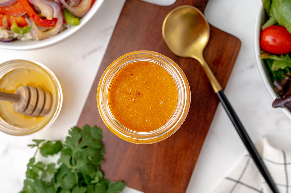 overhead of honey chipotle dressing in a glass jar