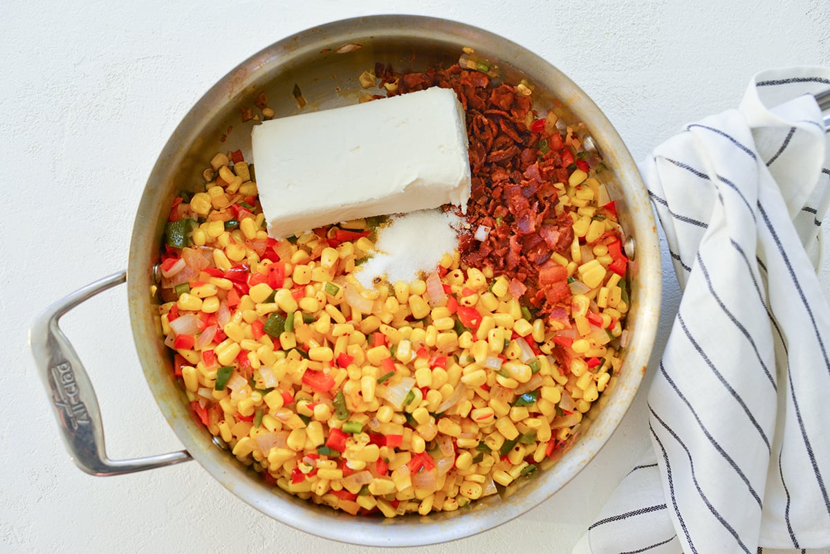 skillet with corn, diced peppers, onions, cream cheese and spices