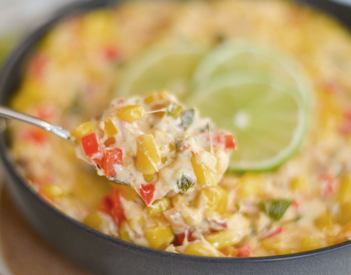 spoon holding hot mexican corn dip recipe