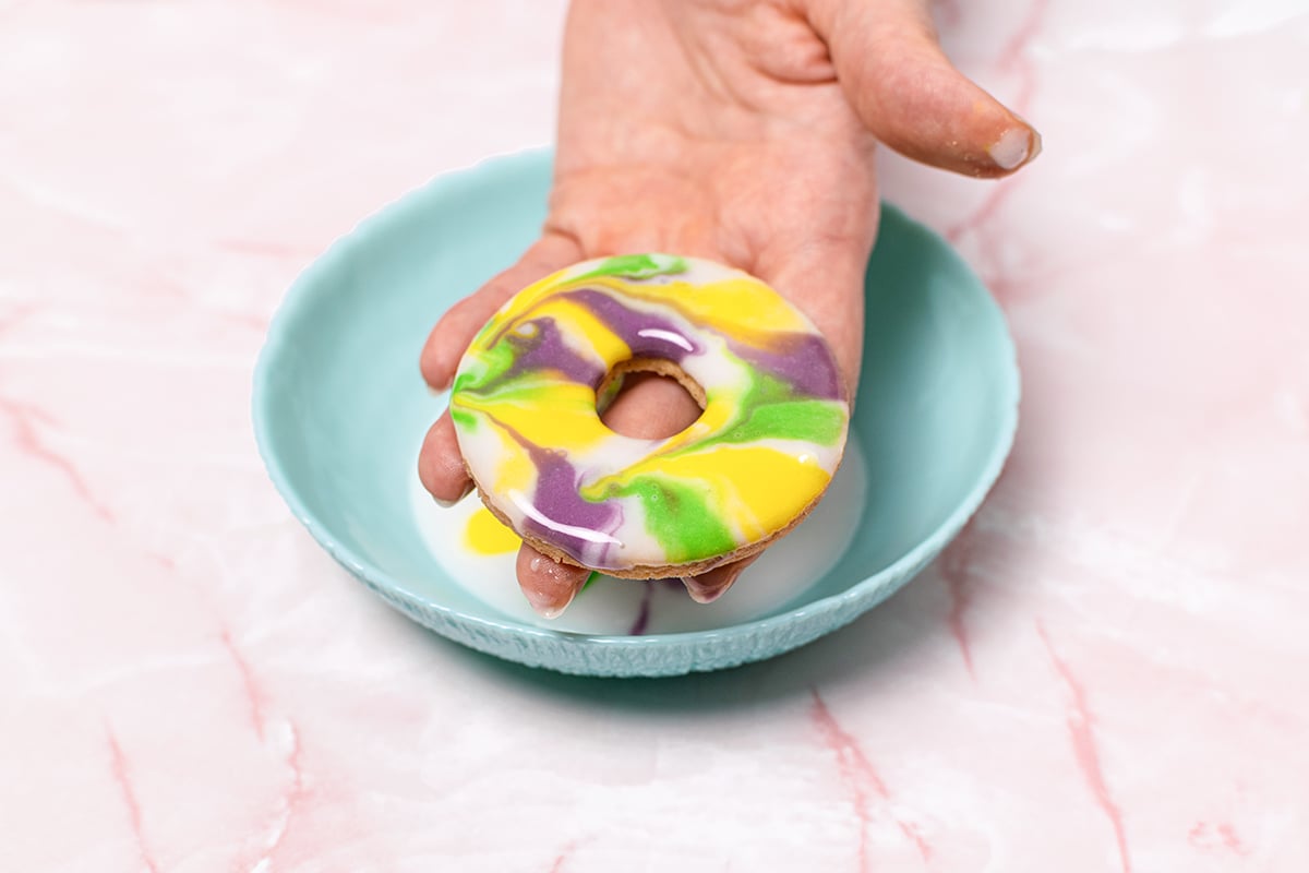 hand holding a marbled frosting cookie 